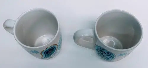 Two white ceramic mugs with Norfolk Blue Green and Blue Green Teal paisley patterns