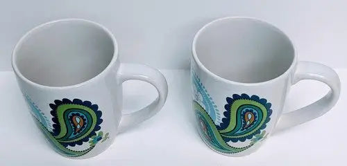 Two white ceramic mugs with Norfolk Blue Green and Blue Green Teal paisley patterns