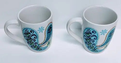 Two white ceramic mugs with Norfolk Blue Green and Blue Green Teal paisley designs