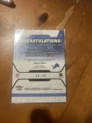 Joey Harrington game-worn jersey card from Fleer Authentix Joey series 13/50