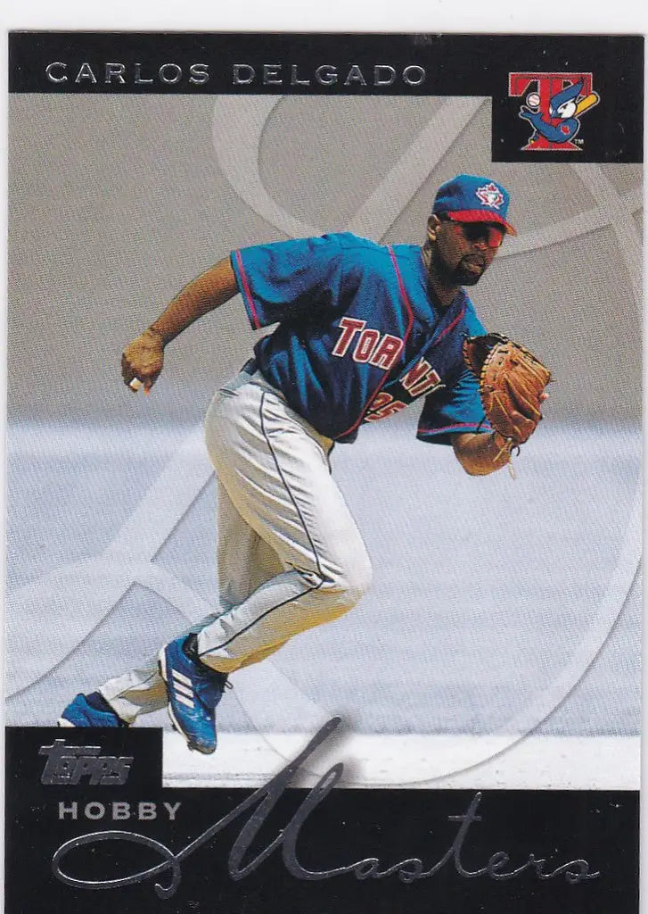 Baseball player fielding a ball in blue uniform, Carlos Delgado trading card