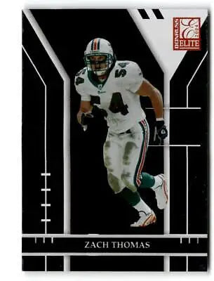 Zach Thomas in action wearing a white Miami Dolphins uniform for Donruss Elite trading cards