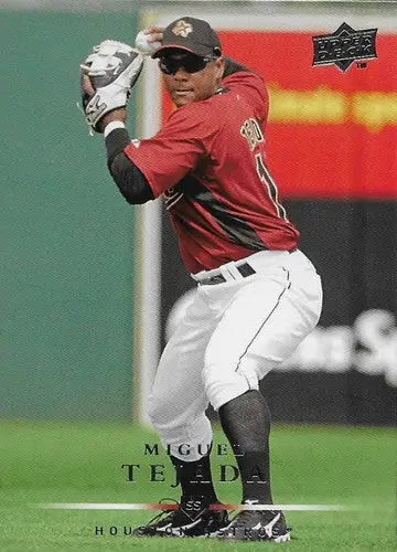 Upper Deck Miguel Tejada baseball card depicting player in fielding stance with original gloss