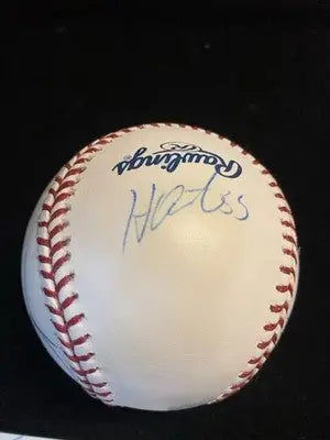 Autographed white baseball with red stitching featuring signatures of Houston Astros, Milo Hamilton, and Nelson Figueroa