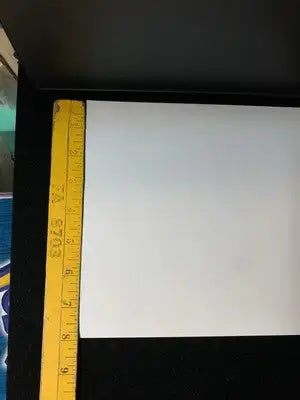 White rectangular paper with yellow measuring tape for Primal Clash Window Cling Promo