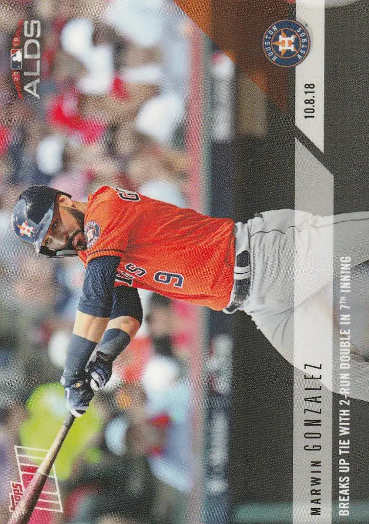 Baseball player Marwin Gonzalez in orange jersey swinging bat for run double Marwin