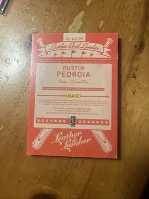 Dustin Pedroia dual relic baseball card from 2019 Panini Lumber And Leather series