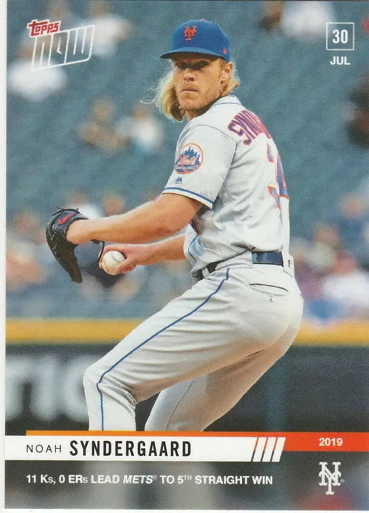 Baseball player Noah Syndergaard mid-pitch in a white Mets uniform on the field