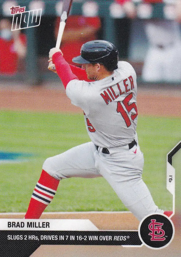 Baseball player Brad Miller in white uniform mid-swing with red bat for St Louis Cardinals