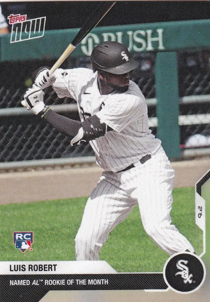 Baseball player in white pinstripes swinging bat for Luis Robert Chicago White Sox
