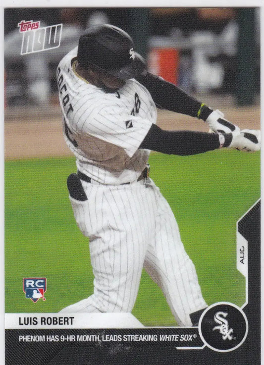 Baseball player Luis Robert in Chicago White Sox pinstripe uniform swinging a bat