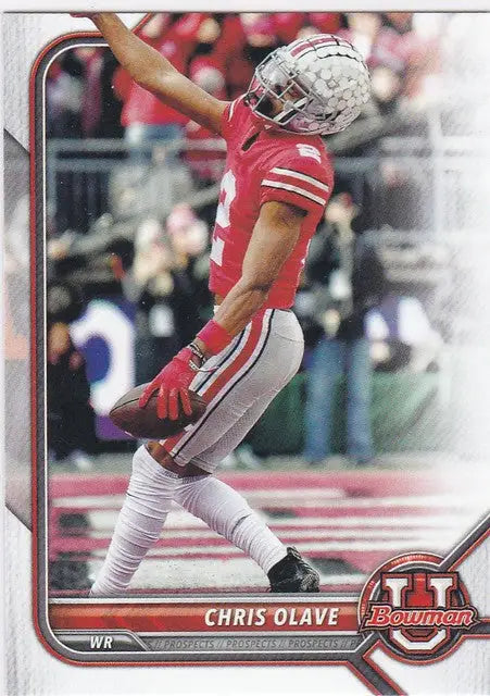 Chris Olave leaps in red Ohio State Buckeyes uniform during a game action shot
