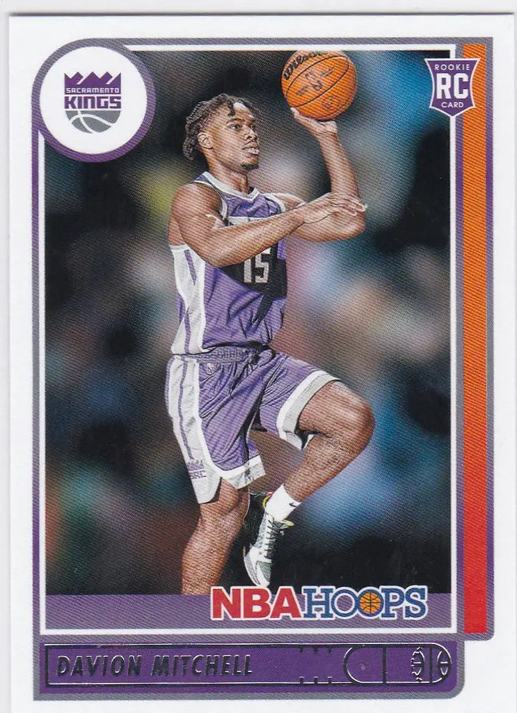 Basketball trading card of Davion Mitchell RC Sacramento Kings in mid-jump with ball