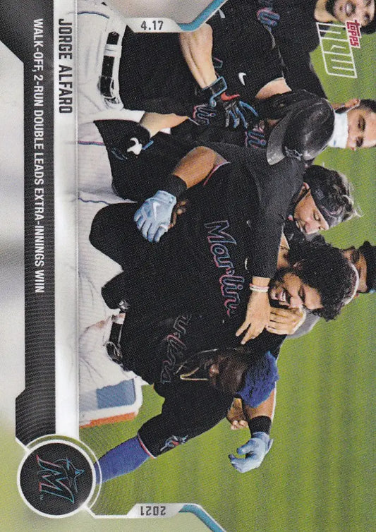 Baseball players in dark uniforms celebrating Jorge Alfaro’s Miami Marlins walk-off double