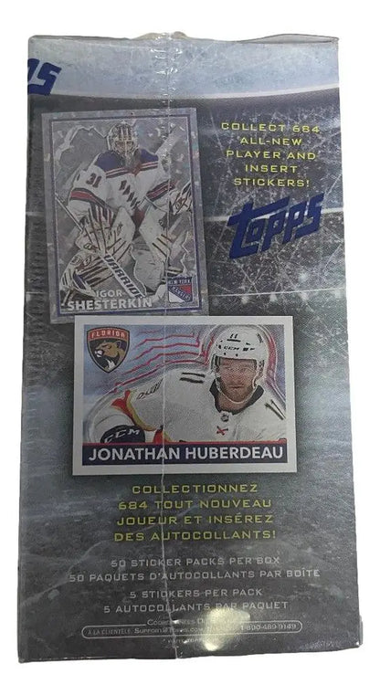 Sealed pack of NHL trading cards and stickers featuring player images and metallic designs
