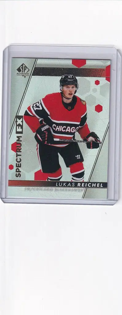 Hockey trading card of Lukas Reichel in Chicago Blackhawks jersey, Authentic Spectrum design