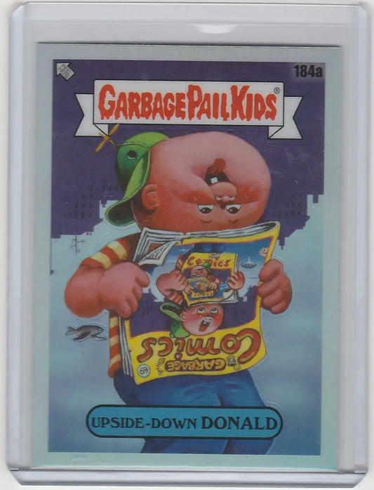 Chrome Garbage Pail Kids card featuring Upside-Down Donald reading a comic