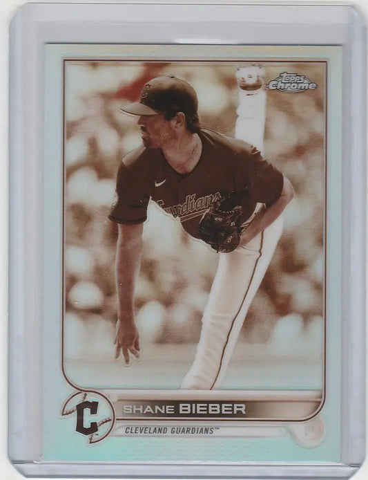 Baseball card of Shane Bieber pitching in dark uniform for Topps Chrome Sepia