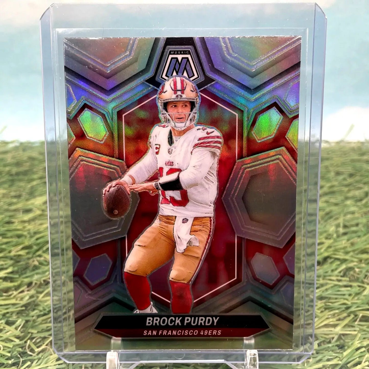 Football trading card of Brock Purdy in white uniform, showcasing Panini Mosaic Silver Prizm
