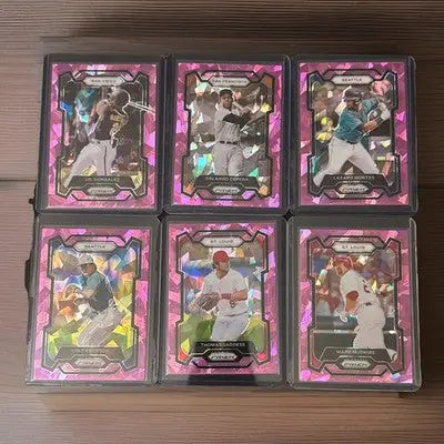 Six pink-framed Panini Prizm Baseball trading cards in protective cases for collectors