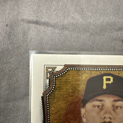Baseball trading card of Paul Skenes in black cap with yellow P logo from Topps Allen Ginter
