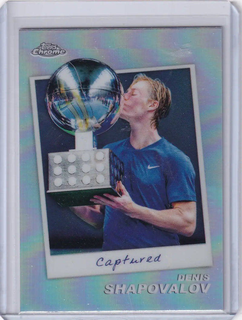 Tennis player Denis Shapovalov kisses trophy in blue Nike shirt for Topps Chrome Captured