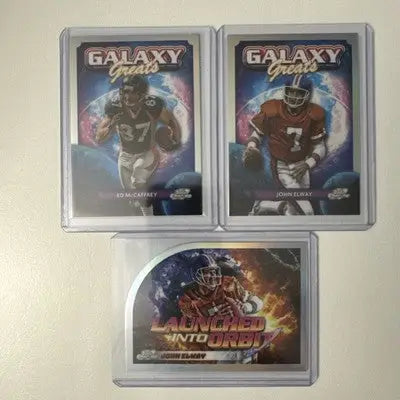 Three football trading cards in protective cases from 2024 Topps Chrome Cosmic Galaxy Greats series