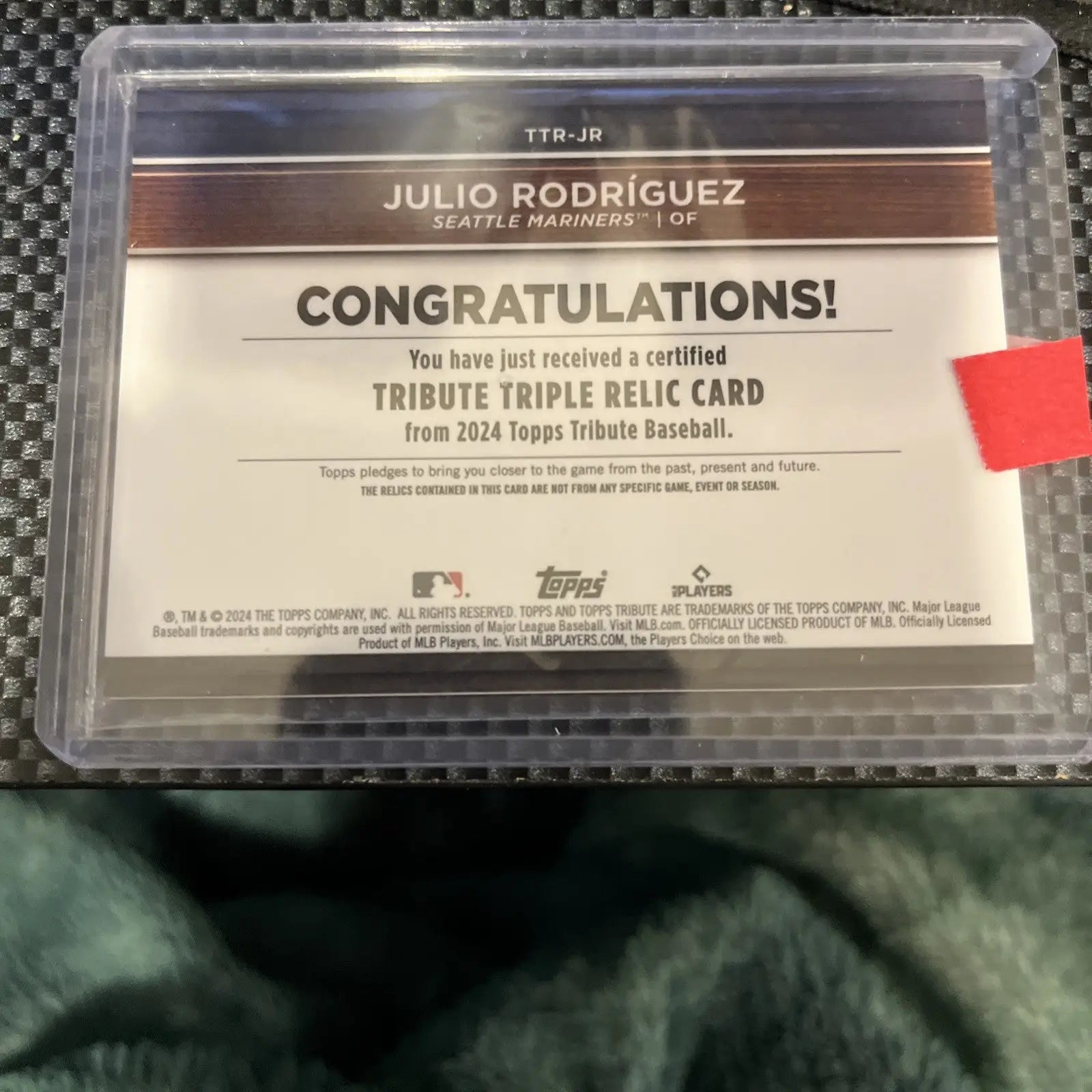 Julio Rodriguez 2024 Topps Tribute Triple Relics baseball card featuring green memorabilia