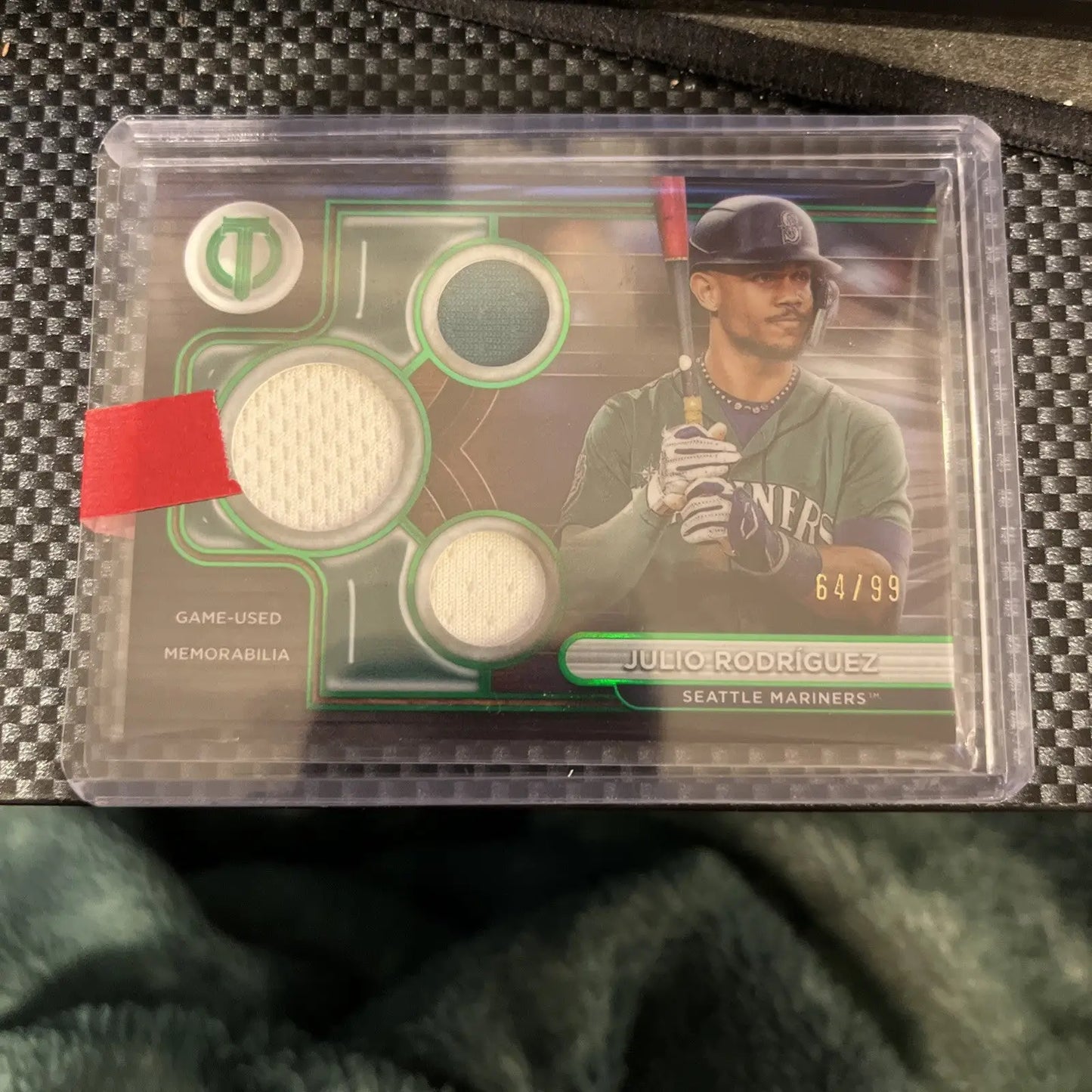Baseball trading card featuring Julio Rodriguez with game-used memorabilia swatches from Topps Tribute Triple Relics