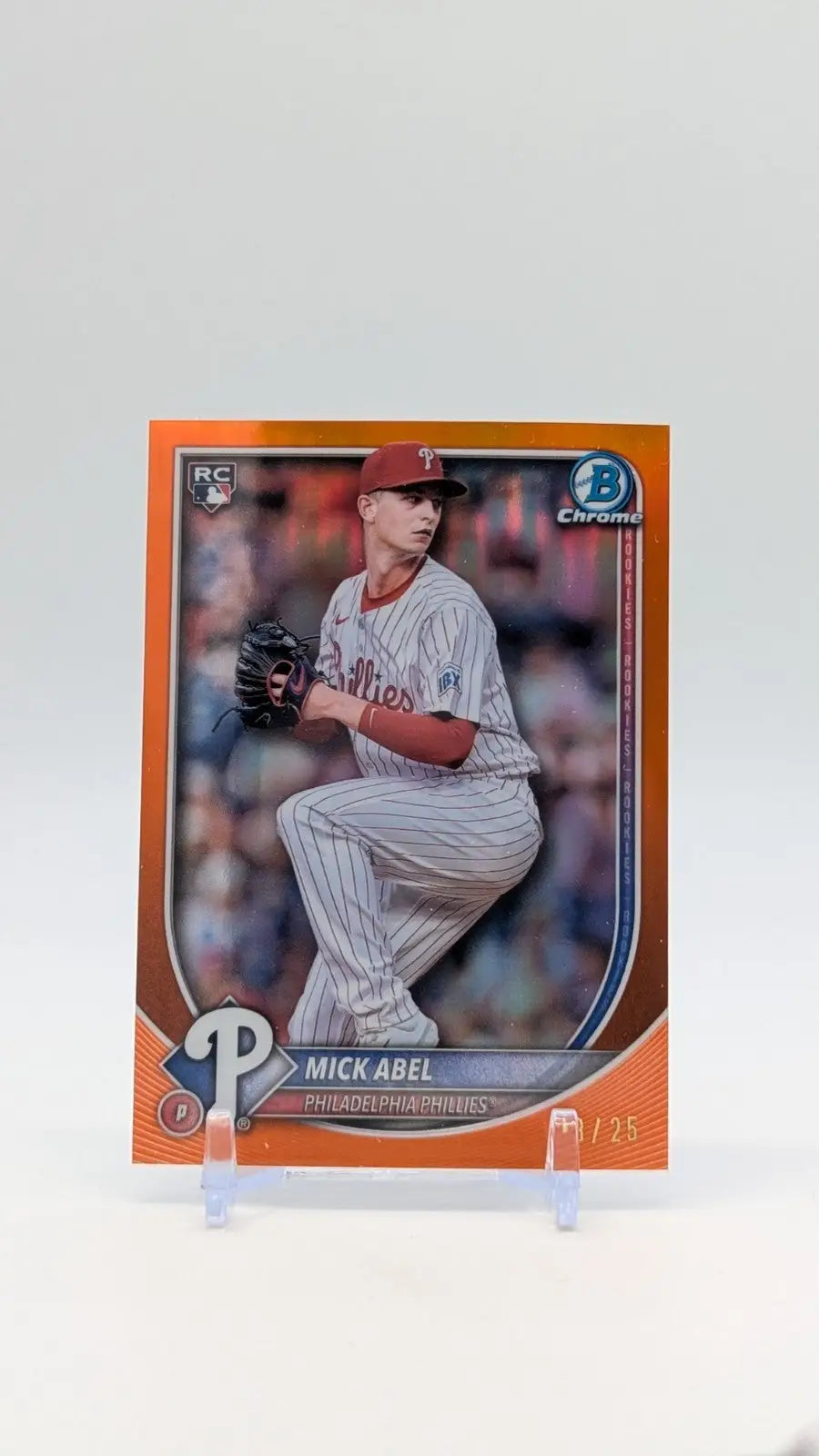 Orange baseball trading card of Mick Abel in pitching stance from Bowman Chrome Mick series