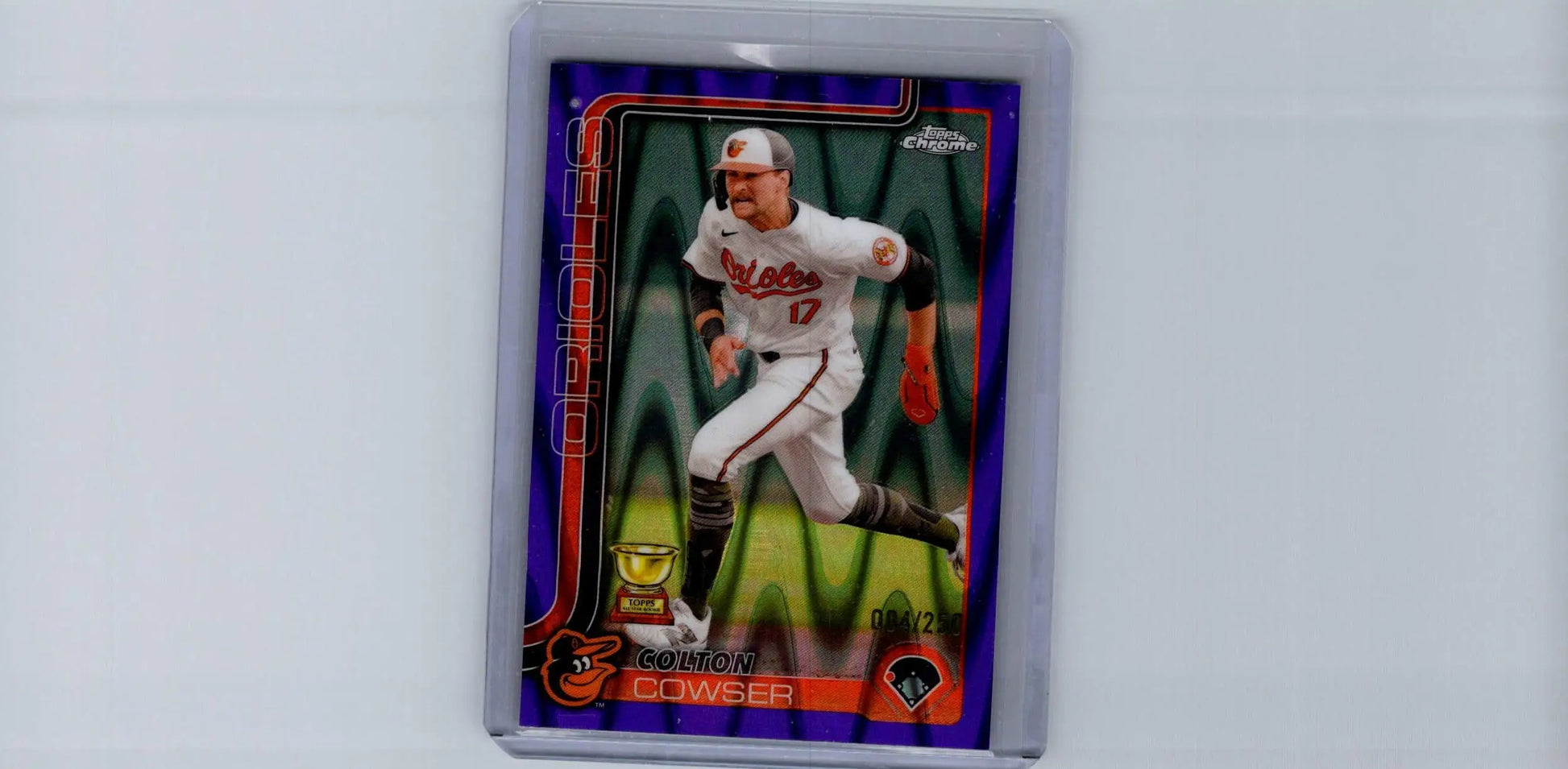 Colton Cowser purple refractors baseball trading card in protective holder featuring running player