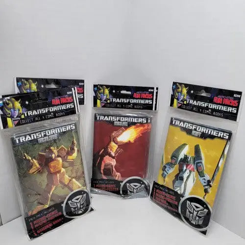 Three sealed Transformers fun packs with micro comic, poster, and bonus items included