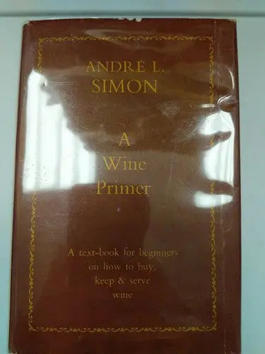 Vintage hardcover book on wine primer displayed on store shelf pulls in library