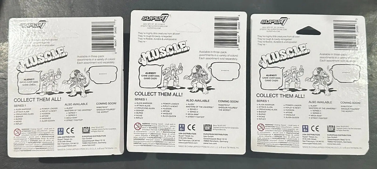 Three MUSCLE toy packaging cards from Aliens Super7 M.U.S.C.L.E. Sets collectible trading cards