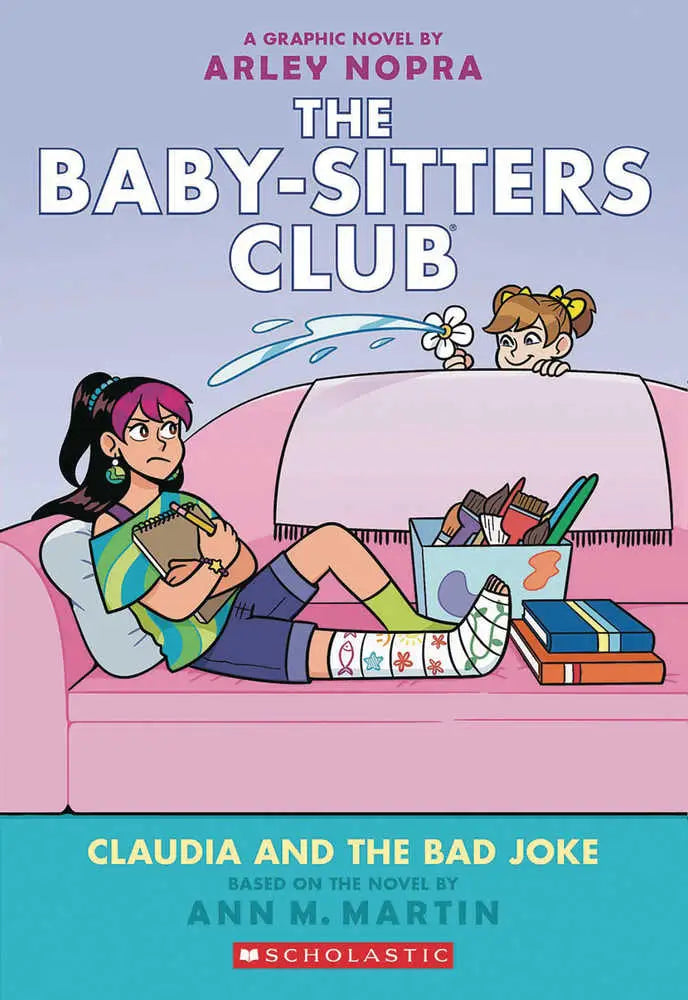 Baby Sitters Club Graphic Novel Volume 15 with two girls, one with a broken leg, on a pink couch featuring Betsy Sobak artwork