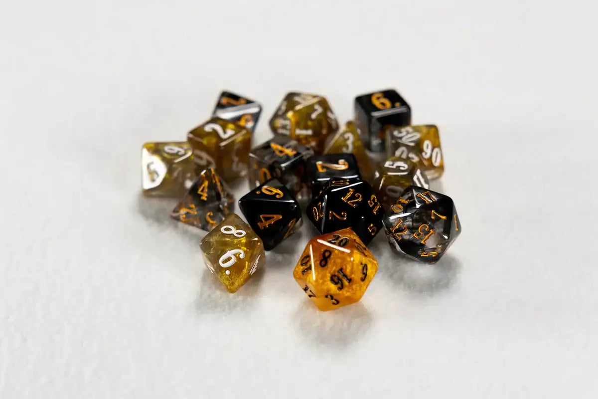 Translucent amber and black character class dice for the Game Master by Beadle & Grimm