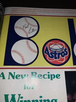 Baseball-themed Houston Astros souvenir program scorebook featuring a magazine page and Nolan Ryan