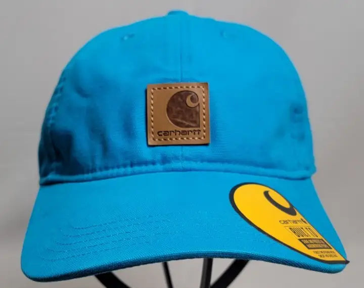 Vibrant blue Carhartt FORCE Canvas Patch Adjustable Cap with brown leather logo patch