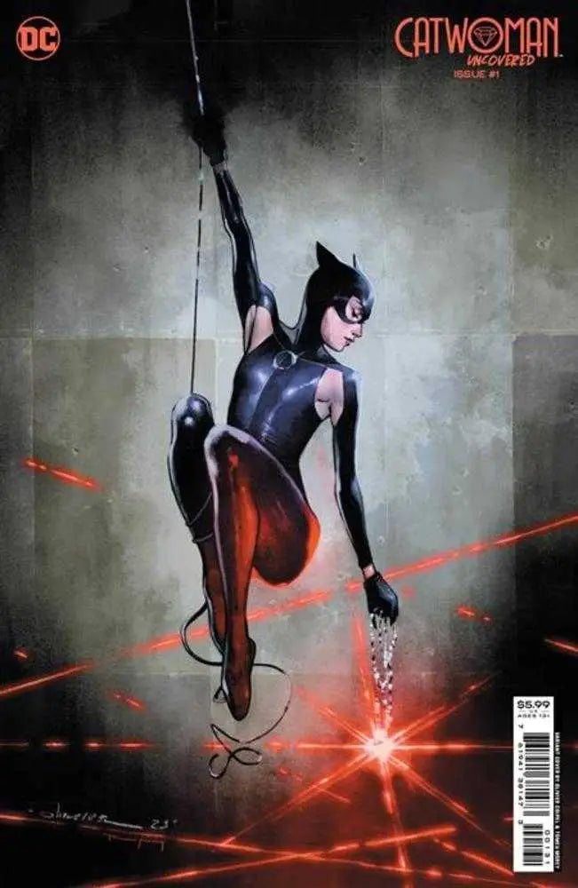 Catwoman in sleek black costume swinging with whip amid red laser beams cover art