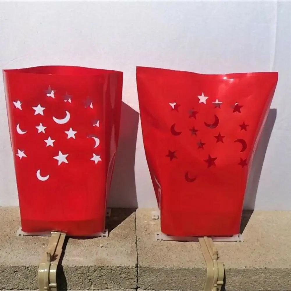 Red decorative lanterns with star and moon cutouts from Classic Holiday LUMINARY SET for electric luminarias