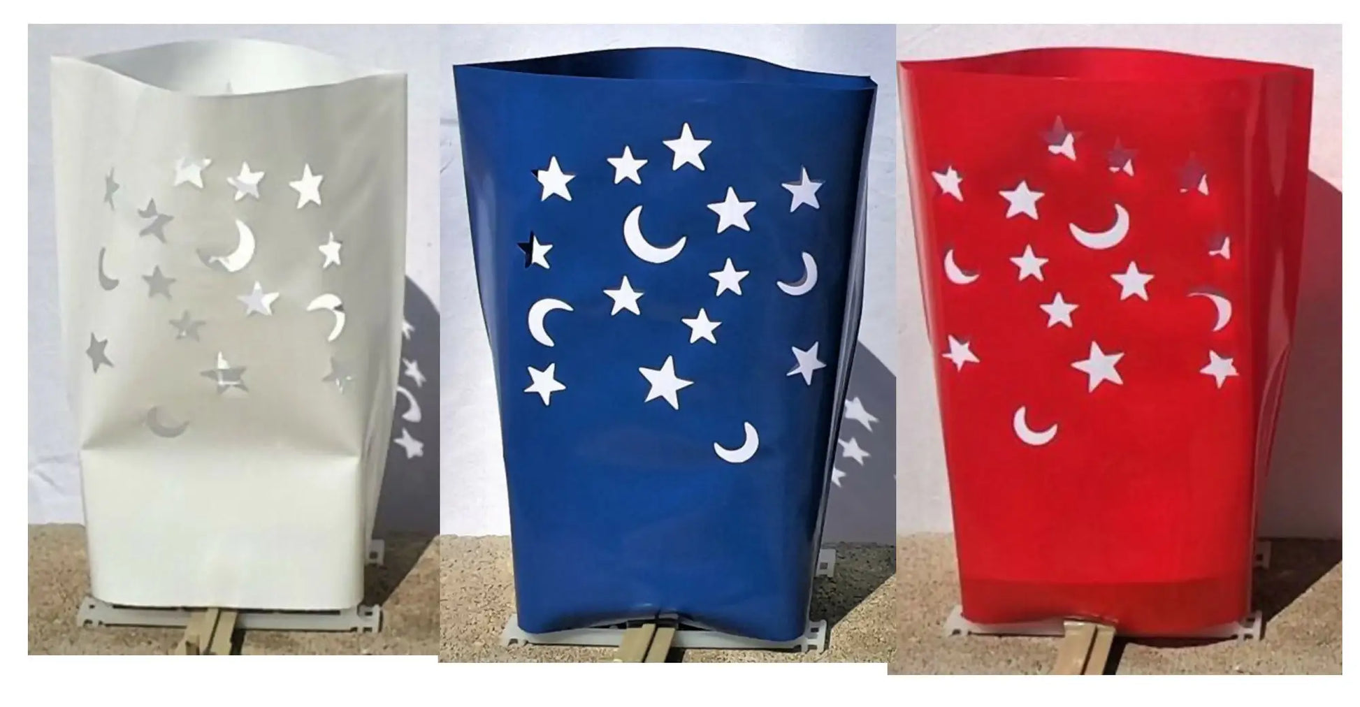 Decorative outdoor electric luminarias with moon and star cutouts for holidays