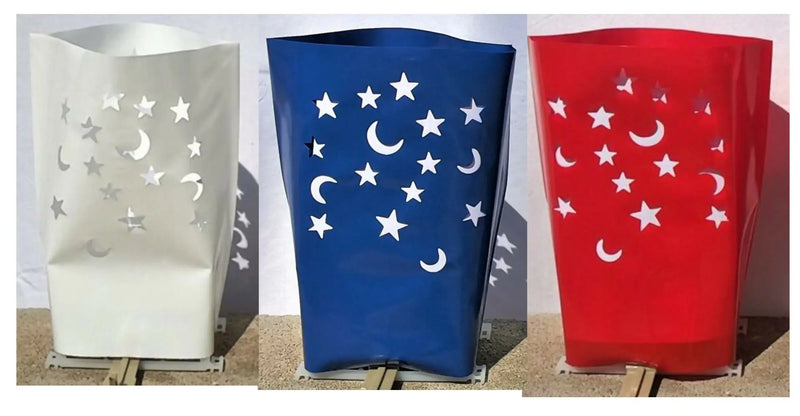 Decorative outdoor electric luminarias with moon and star cutouts for holidays