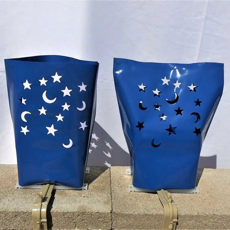 Blue plastic lanterns with moon and star cutouts from Classic LUMINARY SET, ideal for luminarias bags