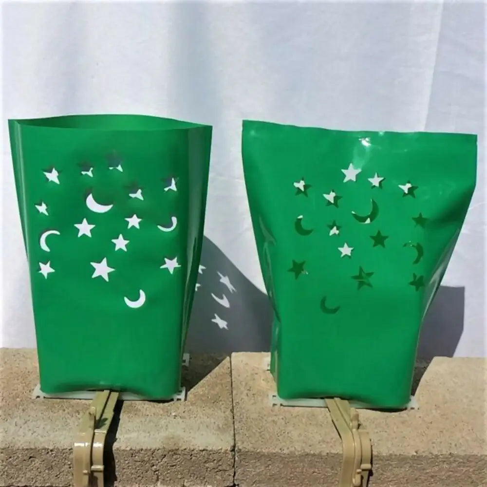 Green translucent luminarias bags with star and crescent moon cutouts for electric luminarias