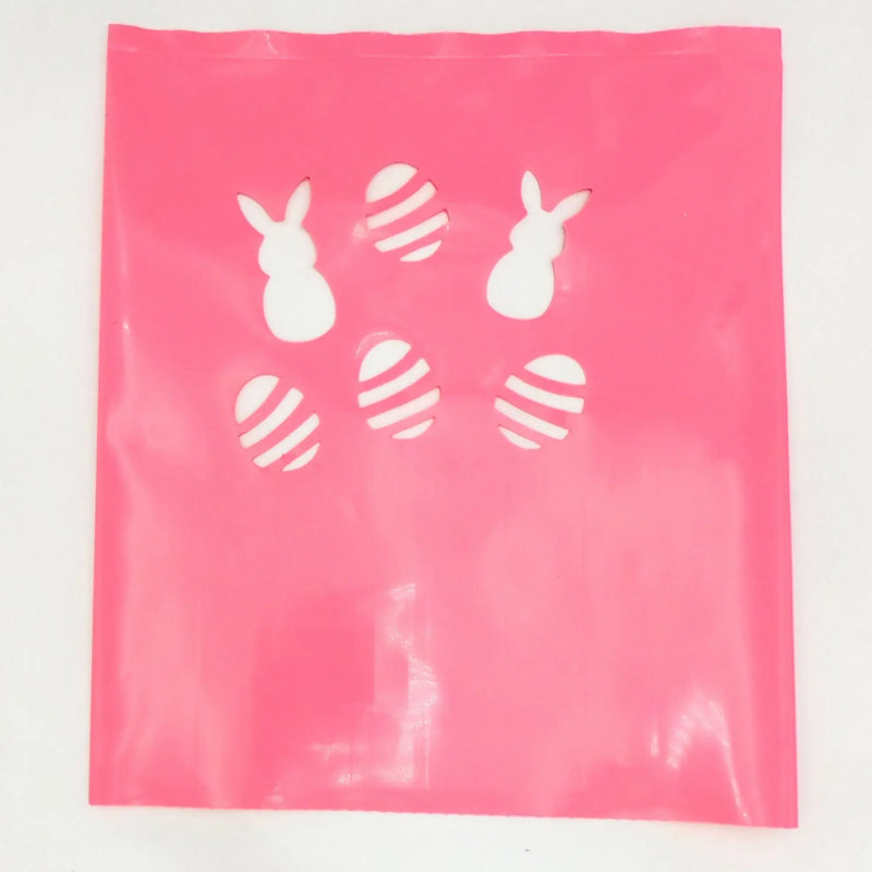 Pink plastic bag with white Easter bunny and egg cutouts for luminarias bags in Classic LUMINARY SET