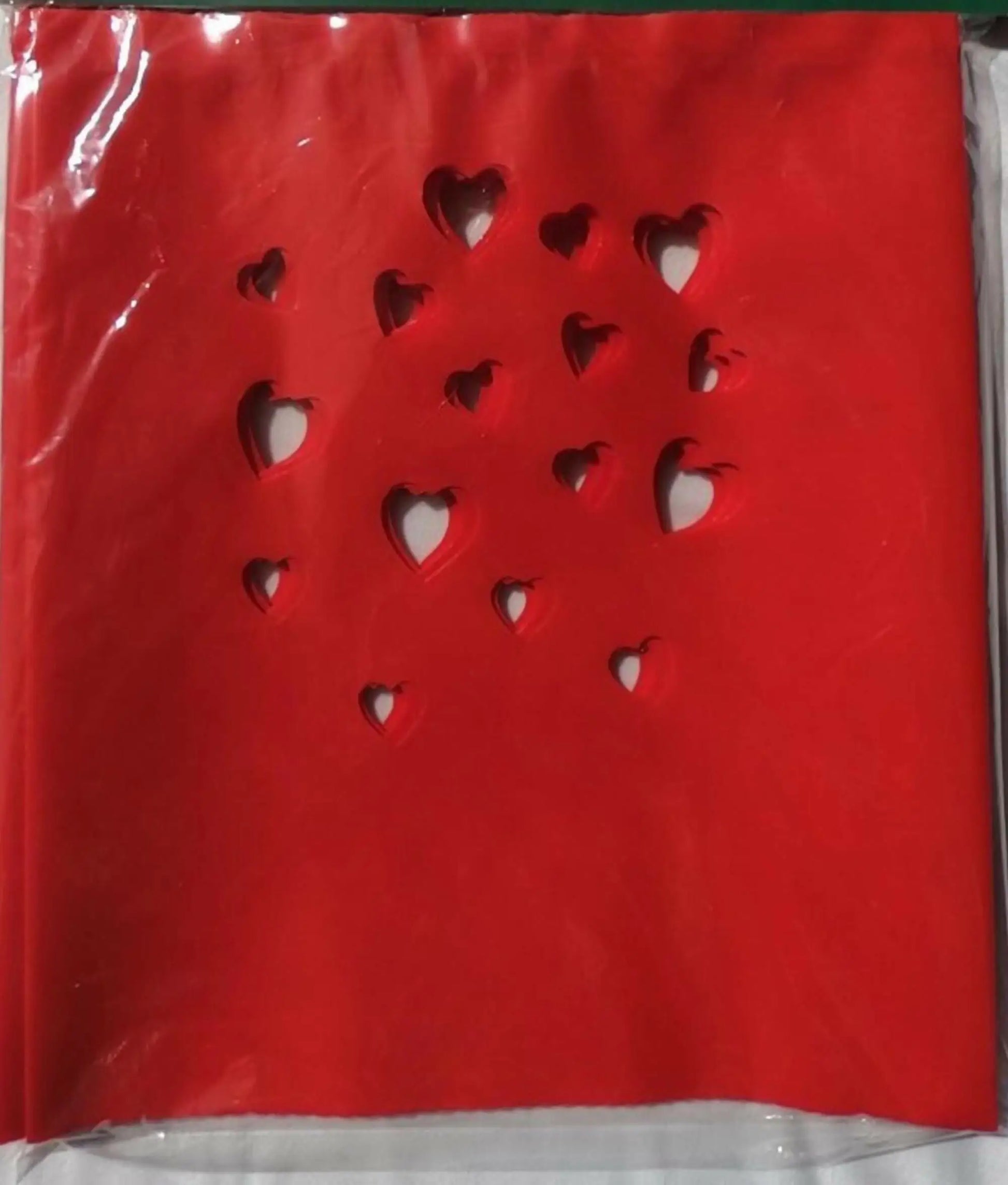 Red paper notebook with heart-shaped cutouts from Classic LUMINARY SET, perfect for luminarias bags
