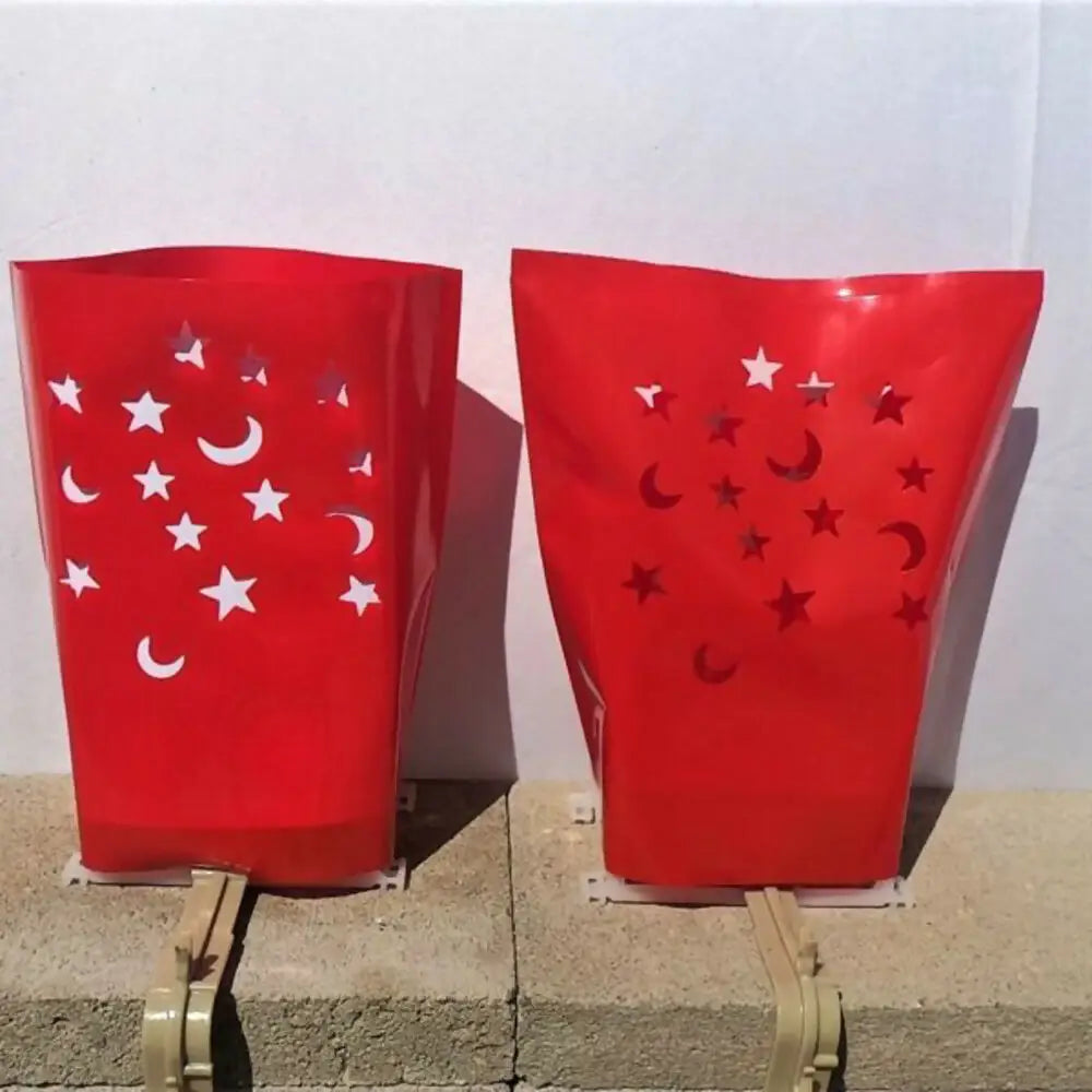 Red decorative lanterns with star and moon cutouts from Classic LUMINARY SET for luminarias bags