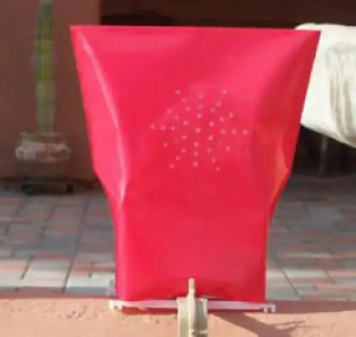 Red plastic laundry hamper with perforated pattern from Classic LUMINARY SET, ideal for luminarias bags
