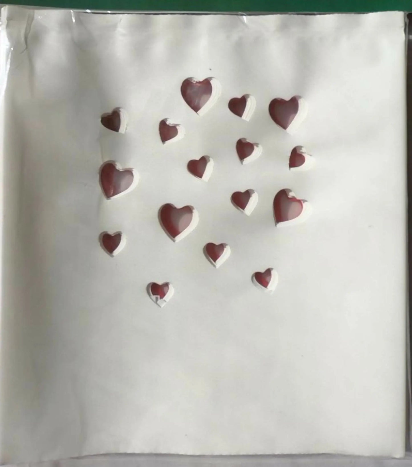 White luminarias bag with red heart cutouts, perfect for electric luminarias and bag clips