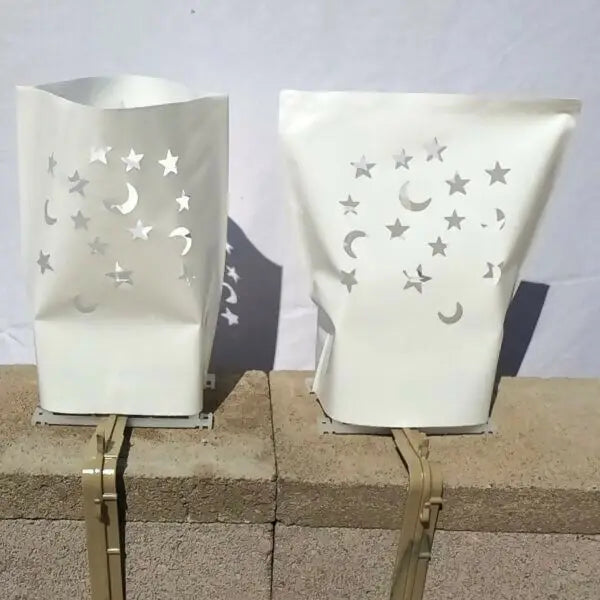White paper luminaries with star and moon cutouts from Classic LUMINARY SET for luminarias bags